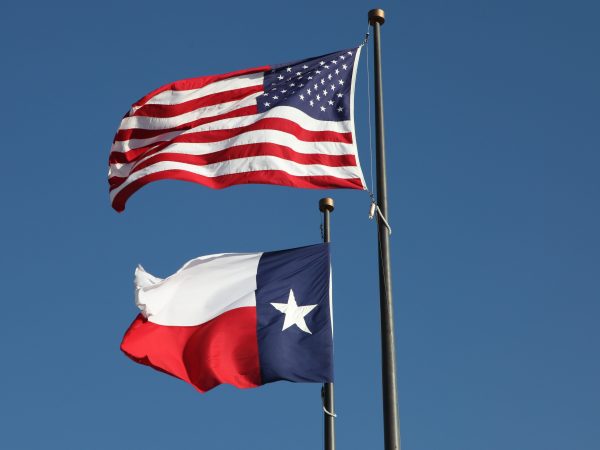 American flag and Texas flag flying at the  LBJ Library in Austin.