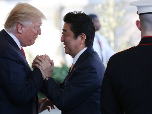 WASHINGTON, DC - FEBRUARY 10:  President Donald Trump (L) greets Japanese Prime Minister Shinzo Abe as he arrives at the White House on February 10, 2017 in Washington, DC. The two will hold a bilateral meeting and press conference today at the White House.  (Photo by Mario Tama/Getty Images)