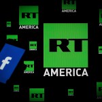 A Facebook logo is seen on a portable device with the logo of Russia Today (RT) news channel in the background in this photo illustration on November 15, 2017. (Photo by Jaap Arriens/NurPhoto)