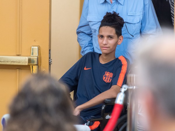 Anthony Borges, 15, who was shot five times on February 14th in the Marjory Stoneman Douglas massacre, is helped into a news conference by his grandfather at the Sheraton Suites Plantation on Friday, April 6, 2018, in Plantation, Fla. Still recovering after he used his body as a human shield to protect the lives of his fellow classmates, he was not able to speak during the conference. (Jennifer Lett/Sun Sentinel/TNS)