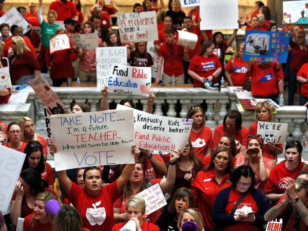 FRANKFORT, KY-APRIL 13: Kentucky Public school teachers protest outside the Kentucky House Chamber as they rally for a "day of action" at the Kentucky State Capitol to try to pressure legislators to override Kentucky Governor Matt Bevin's recent veto of the state's tax and budget bills April 13, 2018 in Frankfort, Kentucky. The teachers also oppose a controversial pension reform bill which Gov. Bevin signed into law. (Photo by Bill Pugliano/Getty Images)