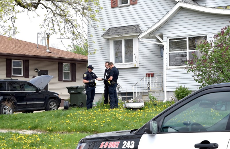 Fort Dodge Police officers Matt Weir, left, Larry Hedlund and Jacob Naatz investigate an accidental shooting, Wednesday, May 9, 2018, in Fort Dodge, Iowa. Richard Remme, of Fort Dodge, told police he was playing with his dog, Balew, on the couch and tossed the dog off his lap. He says when the pit bull-Labrador mix bounded back up, he must have disabled the safety on the gun in his belly band and stepped on the trigger causing the gun to fire and strike Remme in the leg. (Joe Sutter/The Messenger via AP)