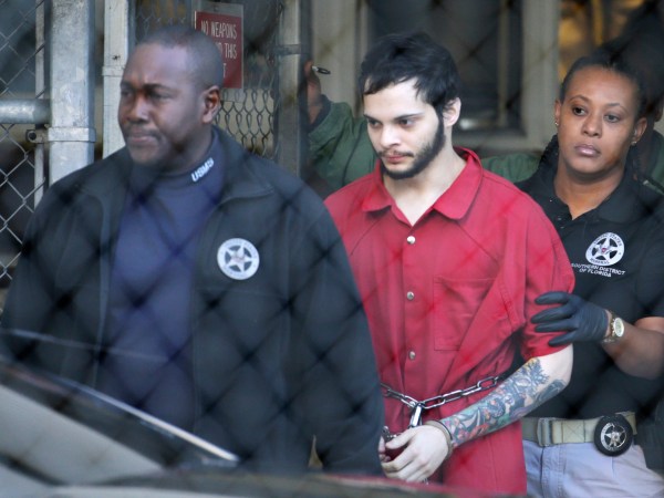 FILE - In this Jan. 30, 2017, file photo, Esteban Santiago, center, is led from the Broward County jail for an arraignment in federal court in Fort Lauderdale, Fla. Court records say Santiago charged with killing five people and wounding six in a shooting rampage at a Florida airport has been found mentally competent and is scheduled to plead guilty later in May 2018. Federal prosecutors said in a court filing late Monday, Monday, May 14, 2018, that Santiago was recently evaluated by a psychologist. (AP Photo/Lynne Sladky, File)