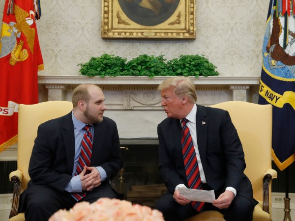 President Donald Trump, right, talks with Joshua Holt, who was recently released from a prison in Venezuela, in the Oval Office of the White House, Saturday, May 26, 2018, in Washington. (AP Photo/Alex Brandon)
