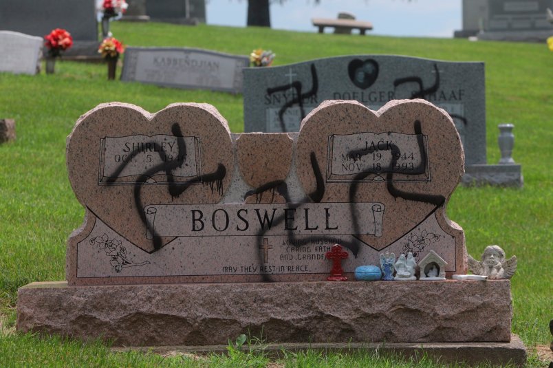 Swastikas were spray-painted on at least 150 headstones and grave markers at a cemetery in Glen Carbon on Saturday, May 26, 2018. Police said swastikas were also spray-painted on several homes nearby. (Photo by Laurie Skrivan/Post-Dispatch)