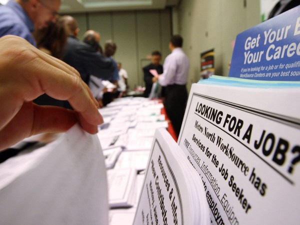 PASADENA, CA - MAY 14:  Job seekers look over job opening fliers at the WorkSource exhibit, a collaborative effort by governmental agencies to offer jobs and job training resources at the Greater Los Angeles Career Expo at the Pasadena Convention Center on May 14, 2009 in Pasadena, California. Nineteen exhibitors offer job and educational opportunities as well as advice from the Board of Equalization at the event that is open to the general public.  (Photo by David McNew/Getty Images)