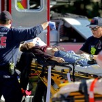 Medical personnel tend to a victim outside of Stoneman Douglas High School in Parkland, Fla., after a shooting on Wednesday, Feb. 14, 2018. (John McCall/Sun Sentinel/TNS)