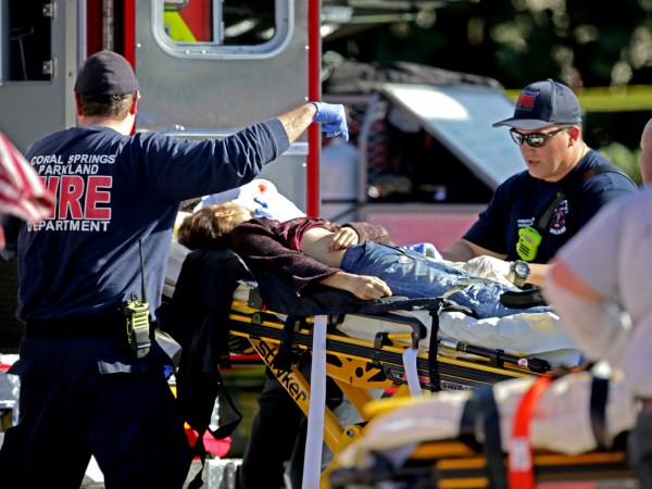Medical personnel tend to a victim outside of Stoneman Douglas High School in Parkland, Fla., after a shooting on Wednesday, Feb. 14, 2018. (John McCall/Sun Sentinel/TNS)
