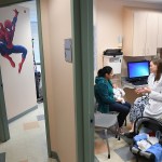 FALLS CHURCH, VA - OCTOBER 31: Ana Elsy Ramirez Diaz holds her son, Milan Rojas Ramirez as he is seen by Dr. Margaret-Anne Fernandez during a check-up visit at INOVA Cares Clinic for Children on Tuesday October 31, 2017 in Falls Church. A portion of the clinic's patients are insured through the Children's Health Insurance Program. (Photo by Matt McClain/The Washington Post via Getty Images)