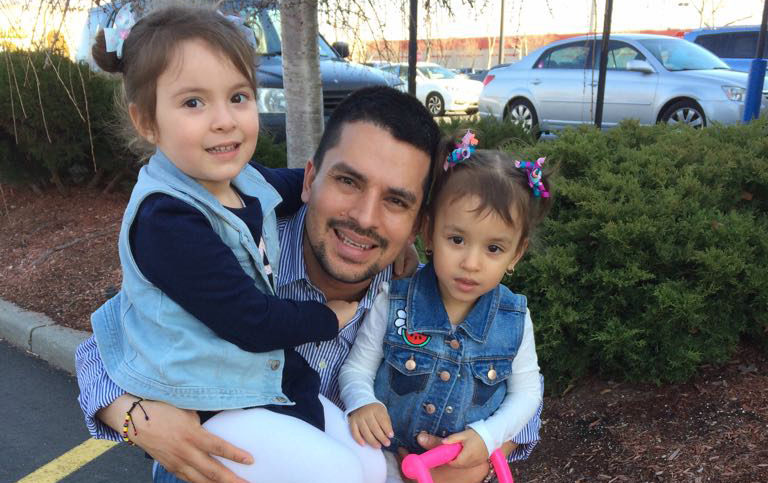 In this undated family photo provided by Sandra Chica, Pablo Villavicencio poses with his two daughters, Luciana, left, and Antonia. After Villavicencio couldn't produce a New York State Driver's License for identification, a guard at the Fort Hamilton in the Brooklyn borough of New York called Immigration and Customs Enforcement on him as he tried to deliver a pizza to the military base. Villavicencio was detained by military police and handed over to ICE pending removal from the country. (Villavicencio Family Photo via AP) .