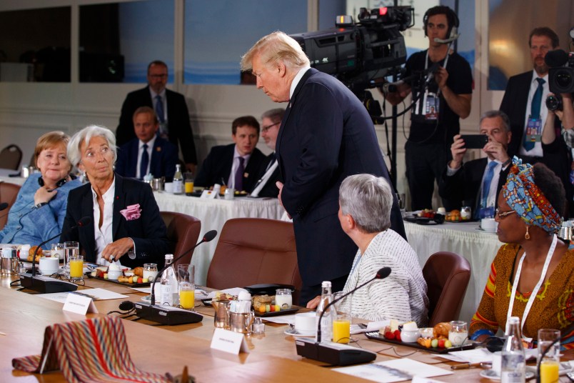 President Donald Trump arrives for a Gender Equality Advisory Council breakfast during the G-7 summit, Saturday, June 9, 2018, in Charlevoix, Canada. From left, German Chancellor Angela Merkel, IMF Managing Director Christine Lagarde, Trump, Christine Whitecross, and Winnie Byanyima. (AP Photo/Evan Vucci)