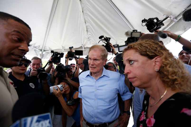 U.S. Sen. Bill Nelson, center and congresswoman Debbie Wasserman Schultz, right, were denied entry by security into the Homestead Temporary Shelter for Unaccompanied Children on Tuesday, June 19, 2018, in Homestead, Fla. (AP Photo/Brynn Anderson)