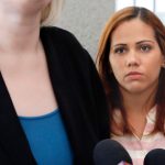 Lidia Karine Souza watches as one of her attorneys speaks outside U.S. District Court in Chicago on Thursday, June 28, 2018. Souza, who is from Brazil, and her son, Diogo, entered the United States in New Mexico in late May and were separated a few days later. The boy has been in a Chicago shelter for about a month. An asylum-seeker due to dangers that Souza says they face in Brazil, she is fighting to get her son back. A judge heard arguments Thursday and said he would issue a ruling soon. (AP Photo/Martha Irvine)