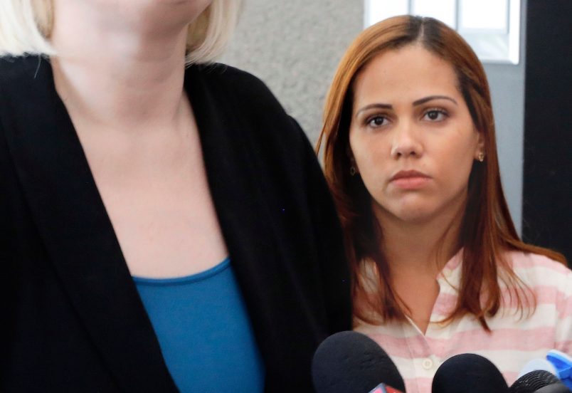 Lidia Karine Souza watches as one of her attorneys speaks outside U.S. District Court in Chicago on Thursday, June 28, 2018. Souza, who is from Brazil, and her son, Diogo, entered the United States in New Mexico in late May and were separated a few days later. The boy has been in a Chicago shelter for about a month. An asylum-seeker due to dangers that Souza says they face in Brazil, she is fighting to get her son back. A judge heard arguments Thursday and said he would issue a ruling soon. (AP Photo/Martha Irvine)