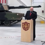 U.S. Ambassador to Estonia James D. Melville Jr. addresses dignitaries in front of an U.S. Army tank, at a hand-over ceremony of the upgraded NATO military base in Tapa, Estonia, Thursday, Dec. 15, 2016. The U.S. military has completed infrastructure investments worth $11.2 million to upgrade the Estonian army base as a part of a U.S. commitment to the alliance's eastern flank, which is facing increasing tensions with Russia. (AP Photo/Vitnija Saldava)