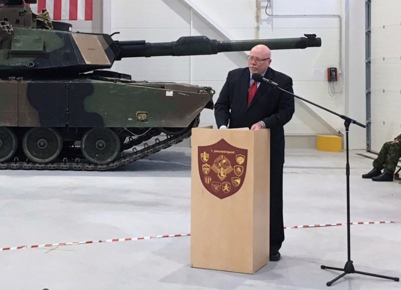 U.S. Ambassador to Estonia James D. Melville Jr. addresses dignitaries in front of an U.S. Army tank, at a hand-over ceremony of the upgraded NATO military base in Tapa, Estonia, Thursday, Dec. 15, 2016. The U.S. military has completed infrastructure investments worth $11.2 million to upgrade the Estonian army base as a part of a U.S. commitment to the alliance's eastern flank, which is facing increasing tensions with Russia. (AP Photo/Vitnija Saldava)