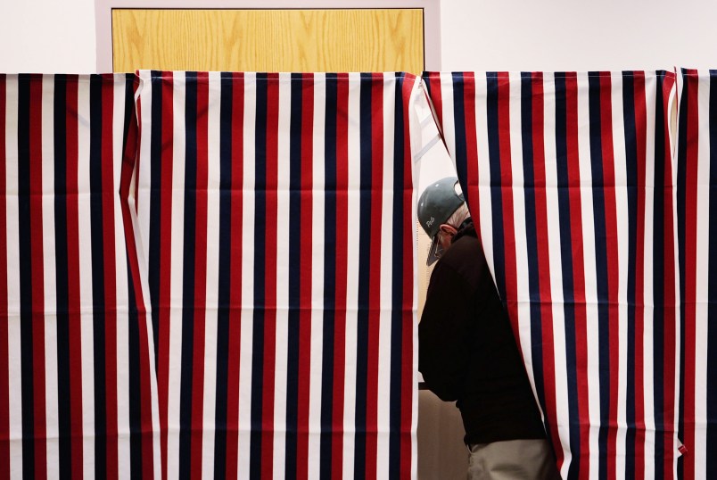 MANCHESTER, NH - JANUARY 08:  A man marks his ballot in a voting booth January 8, 2008 in Manchester, New Hampshire.  Record turnout for the nation's first primary was expected.  (Photo by Chris Hondros/Getty Images)