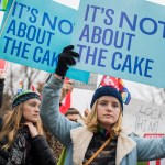 UNITED STATES - DECEMBER 05: Lydia Macy, right, of Berkeley, Calif., siding with a same-sex couple, holds a sign outside Supreme Court where arguments were being on heard on whether a Colorado baker, who refused to make a wedding cake for the couple based on his religious beliefs, is protected by the First Amendment on December 5, 2017. (Photo By Tom Williams/CQ Roll Call)