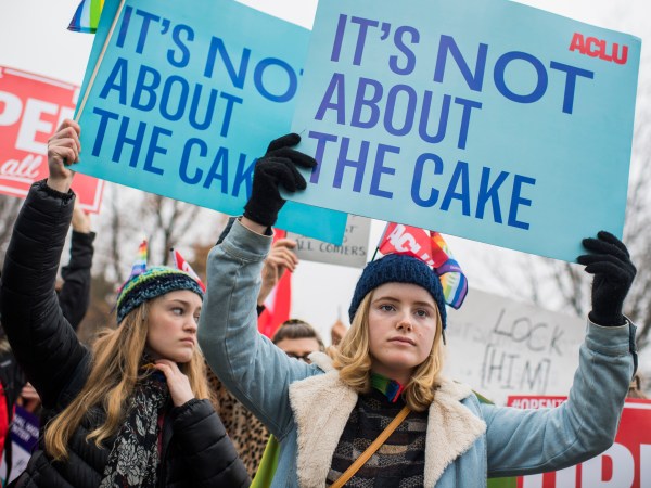 UNITED STATES - DECEMBER 05: Lydia Macy, right, of Berkeley, Calif., siding with a same-sex couple, holds a sign outside Supreme Court where arguments were being on heard on whether a Colorado baker, who refused to make a wedding cake for the couple based on his religious beliefs, is protected by the First Amendment on December 5, 2017. (Photo By Tom Williams/CQ Roll Call)