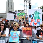 People hold signs as they participate in the "Families Belong Together: Freedom for Immigrants" march on Saturday, June 30, 2018, in Los Angeles. In major cities and tiny towns, marchers gathered across America, moved by accounts of children separated from their parents at the U.S.-Mexico border, in the latest act of mass resistance against President Donald Trump's immigration policies.(Photo by Willy Sanjuan/Invision/AP)