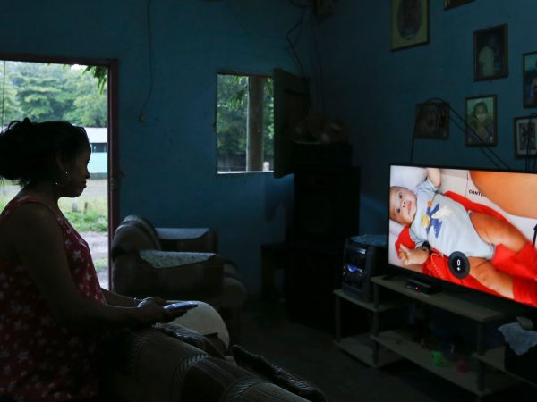 In this July 18, 2018 photo Adalicia Montecinos watches a video at her home, in La Libertad, Honduras of her son Johan Bueso Castillo who was separated from his father at the Texas border. Montecinos watches videos of her infant son Johan over and over again. She had recorded each month of his life before he left for the United States with his father. (AP Photo/Esteban Felix)