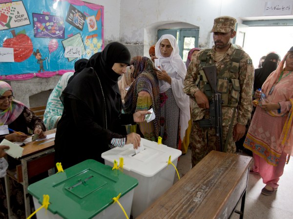 A Pakistani woman casts her vote at a polling station for the parliamentary elections in Rawalpindi, Pakistan, Wednesday, July 25, 2018. After an acrimonious campaign, polls opened in Pakistan on Wednesday to elect the country's third straight civilian election, a first for this majority Muslim nation that has been directly or indirectly ruled by its military for most of its 71-year history. (AP Photo/B.K. Bangash)