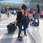 Wanda Collazo escorts her mother Marta Collazo from the arrival area as she departs the Adventure of the Seas after being evacuated from her apartment in Puerto Rico. (Emily Michot/Miami Herald/TNS)