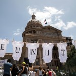 AUSTIN, TX - JUNE 30: A demonstrator uses baby clothes to spell out the word "reunite" during a rally against the Trump administration's immigration policies outside the Texas Capitol in Austin, Texas, on June 30, 2018. Demonstrations are being held in cities across the U.S. Saturday to call for the reunification of separated families and to protest the detention of children and families seeking asylum at the border. (Photo by Tamir Kalifa/Getty Images)