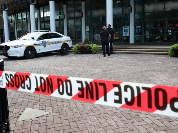 Jacksonville police officers guard an area Monday, Aug. 27, 2018, near the scene of  mass shooting at Jacksonville Landing in Jacksonville, Fla. A gunman opened fire Sunday at an online video game tournament  killing two people and then fatally shooting himself in a rampage that wounded several others. (AP Photo/John Raoux)