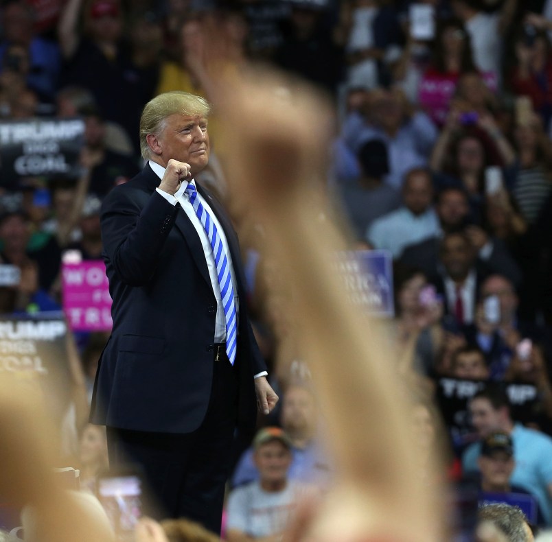 CHARLESTON, WV - AUGUST 21:  People cheer as President Donald Trump speaks at a rally on August 21, 2018 in Charleston, West Virginia. Paul Manafort, a former campaign manager for Donald Trump and a longtime political operative, was found guilty of eight financial crimes Tuesday in a Washington court. In further developments for the president, his former lawyer, Michael Cohen, has plead guilty in New York as part of a separate deal withÊprosecutors.  (Photo by Spencer Platt/Getty Images) *** Local Caption *** Donald Trump