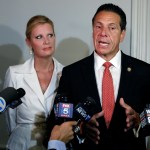 New York Gov. Andrew Cuomo is accompanied by his girlfriend Sandra Lee as he talks to the press after casting his primary election ballot, at the Presbyterian Church of Mount Kisco, in Mt. Kisco, NY, Thursday, Sept. 13, 2018. (AP Photo/Richard Drew)