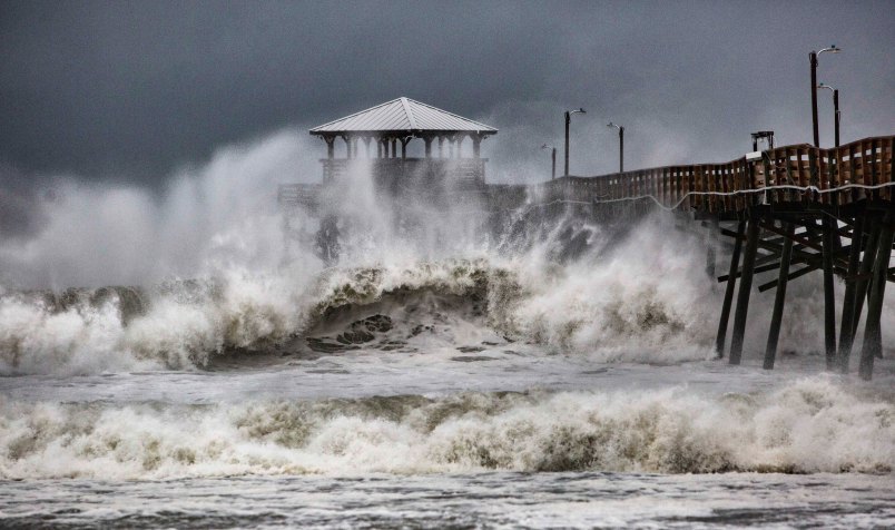 Waves slam the Oceana Pier & Pier House Restaurant in Atlantic Beach, N.C.,  Thursday, Sept. 13, 2018 as Hurricane Florence approaches the area. (Travis Long /The News & Observer via AP)