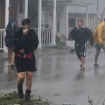 A person shields her face from the wind as Hurricane Florence hit downtown Swansboro N.C.,Friday, Sept. 14, 2018.  (AP Photo/Tom Copeland)