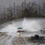 A car drives through water on U.S. 74/76 in Leland, N.C., Saturday, September 15, 2018. The rain from Hurricane Florence was expected to continue through Sunday.         [Matt Born/StarNews Photo]