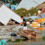 A man surveys the damage caused by earthquake and tsunami in Palu, Central Sulawesi, Indonesia, Saturday, Sept. 29, 2018. The powerful earthquake rocked the Indonesian island of Sulawesi on Friday, triggering a 3-meter-tall (10-foot-tall) tsunami that an official said swept away houses in at least two cities. (AP Photo/Rifki)