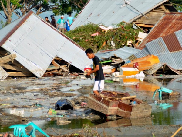 A man surveys the damage caused by earthquake and tsunami in Palu, Central Sulawesi, Indonesia, Saturday, Sept. 29, 2018. The powerful earthquake rocked the Indonesian island of Sulawesi on Friday, triggering a 3-meter-tall (10-foot-tall) tsunami that an official said swept away houses in at least two cities. (AP Photo/Rifki)