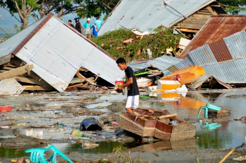 A man surveys the damage caused by earthquake and tsunami in Palu, Central Sulawesi, Indonesia, Saturday, Sept. 29, 2018. The powerful earthquake rocked the Indonesian island of Sulawesi on Friday, triggering a 3-meter-tall (10-foot-tall) tsunami that an official said swept away houses in at least two cities. (AP Photo/Rifki)