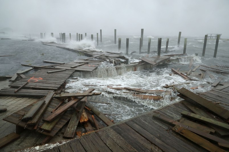 Waves crash around the Oceana Pier as the outer edges of Hurricane Florence being to affect the coast September 13, 2018 in Atlantic Beach, United States. Coastal cities in North Carolina, South Carolina and Virgnia are under evacuation orders as the Category 2 hurricane approaches the United States.