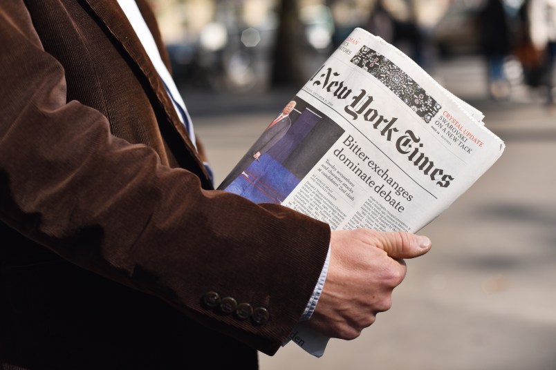 Man holding the New York Times in his hand