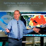 National Hurricane Center director Ken Graham, gestures as he talks about storm surge during a televised update on the status of Hurricane Michael, Tuesday, Oct. 9, 2018, at the Hurricane Center in Miami. At least 120,000 people along the Florida Panhandle were ordered to clear out Tuesday as Hurricane Michael rapidly picked up steam in the Gulf of Mexico and closed in with winds of 110 mph (175 kph) and a potential storm surge of 12 feet (3.7 meters). (AP Photo/Wilfredo Lee)