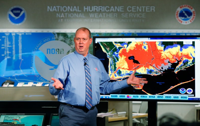 National Hurricane Center director Ken Graham, gestures as he talks about storm surge during a televised update on the status of Hurricane Michael, Tuesday, Oct. 9, 2018, at the Hurricane Center in Miami. At least 120,000 people along the Florida Panhandle were ordered to clear out Tuesday as Hurricane Michael rapidly picked up steam in the Gulf of Mexico and closed in with winds of 110 mph (175 kph) and a potential storm surge of 12 feet (3.7 meters). (AP Photo/Wilfredo Lee)