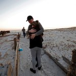 Matthew Fortner hugs his mother Lavonia Fortner, as they walk to view the beach for what they feel is the last time, after they sifted through the rubble of her father-in-laws destroyed home, in the aftermath of Hurricane Michael in Mexico Beach, Fla., Saturday, Oct. 13, 2018. John E. Fortner, not pictured, a Mexico Beach resident, came with his family to find memorabilia his wife collected, which is now scattered amidst the rubble of his obliterated home. (AP Photo/Gerald Herbert)