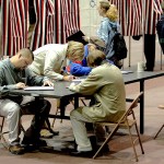 A group of voters fill out their ballots at a table rather than wait for an empty voting booth Tuesday, Nov. 2, 2004, at the Civic Center in Dodge City, Kan. Depending on their precinct, voters had to wait in line to receive a ballot and some had to wait in line for an empty booth. (AP Photo/Dodge City Daily Globe, Michael Schweitzer)