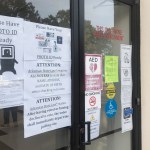 A sign outside the Pulaski County Regional Building in Little Rock, Ark., advises voters on Monday, Oct. 22, 2018, of a state law requiring them to show photo identification before casting a ballot. Early voting began Monday for Arkansas' November 6 midterm election. (AP Photo/Andrew DeMillo)