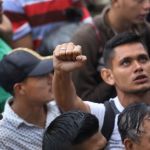 TECUN UMAN, GUATEMALA - OCTOBER 19: Members of a migrant caravan gather before attempting to cross the Guatemalan border into Mexico on October 19, 2018 in Tecun Uman, Guatemala. The caravan of thousands of Central Americans, mostly from Honduras, hopes to eventually reach the United States. U.S. President Donald Trump has threatened to cancel the recent trade deal with Mexico and withhold aid to Central American countries if the caravan isn't stopped before reaching the U.S.  (Photo by John Moore/Getty Images)