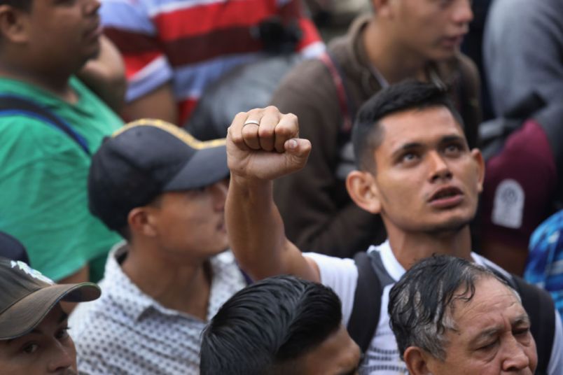 TECUN UMAN, GUATEMALA - OCTOBER 19: Members of a migrant caravan gather before attempting to cross the Guatemalan border into Mexico on October 19, 2018 in Tecun Uman, Guatemala. The caravan of thousands of Central Americans, mostly from Honduras, hopes to eventually reach the United States. U.S. President Donald Trump has threatened to cancel the recent trade deal with Mexico and withhold aid to Central American countries if the caravan isn't stopped before reaching the U.S.  (Photo by John Moore/Getty Images)