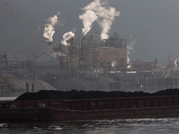 Just south of Charleston a coal barge travels up the Kanawha River, passing the Dupont chemical plant.