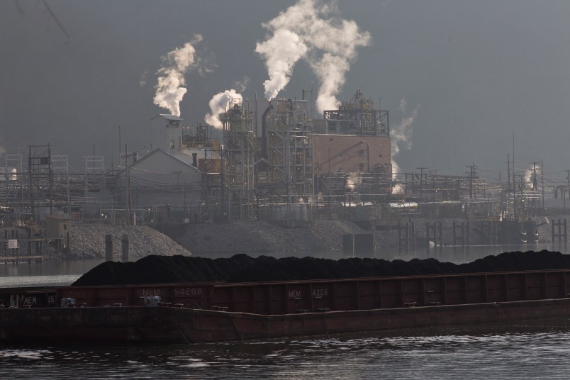 Just south of Charleston a coal barge travels up the Kanawha River, passing the Dupont chemical plant.