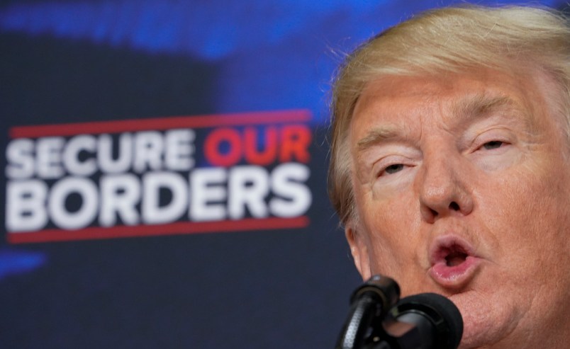 US President Donald Trump speaks on immigration in the South Court Auditorium, next to the White House on June 22, 2018 in Washington, DC, next to people holding posters of victims allegedly killed by illegal immigrants. (Photo by Mandel NGAN / AFP)        (Photo credit should read MANDEL NGAN/AFP/Getty Images)