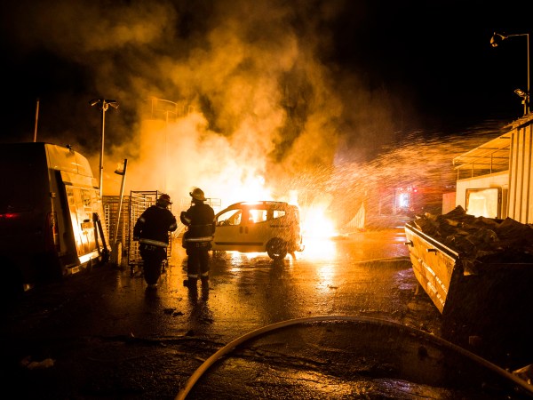 Israeli firefighters work at the scene where a rocket fired from the Gaza Strip hit in Sderot, Israel, Monday, Nov. 12, 2018. Israel's military says it is prepared to step up its efforts against Palestinian militants in the Gaza Strip if rocket fire at Israel continues. (AP Photo/Tsafrir Abayov)